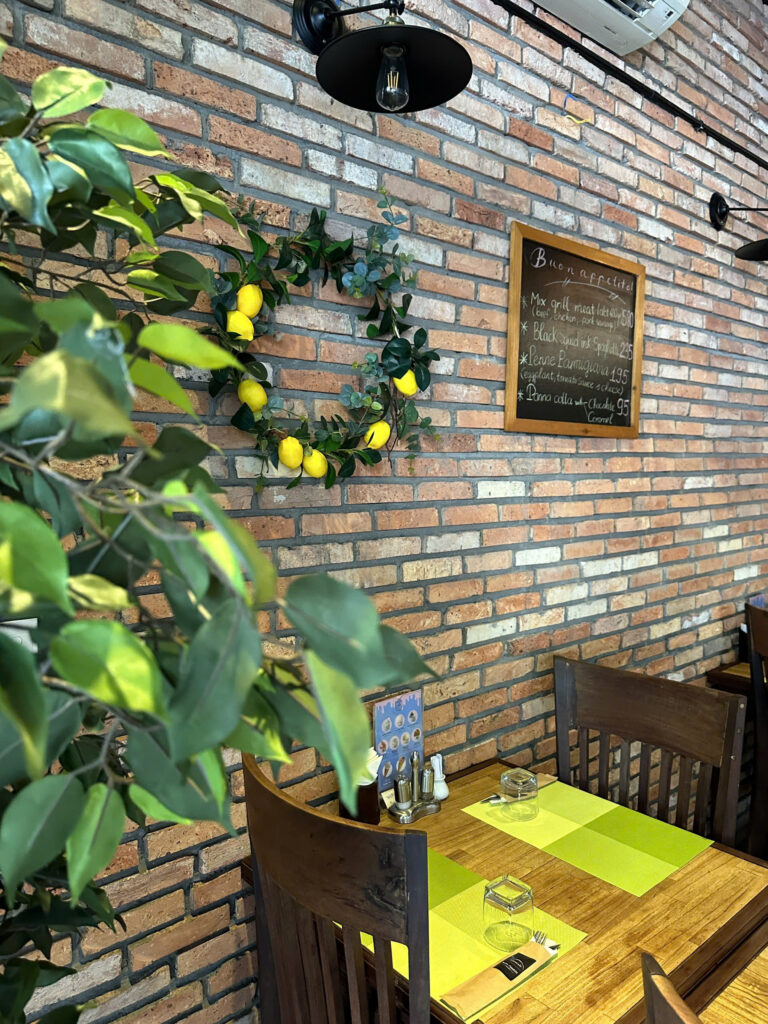 Limoncello dining room with brick wall and lemon decor